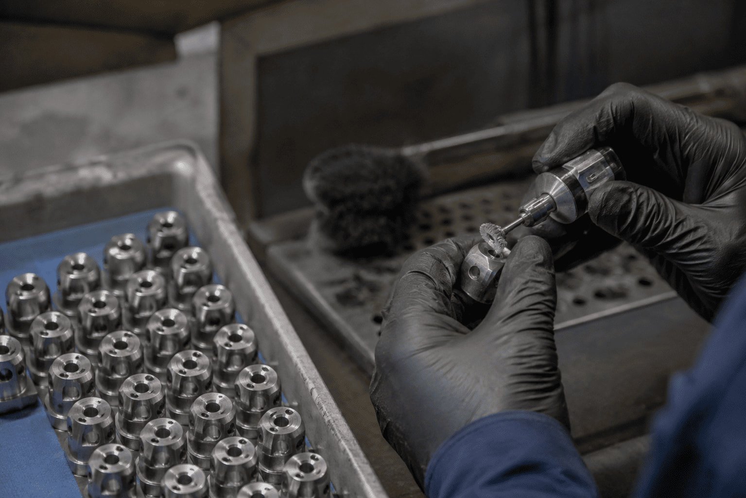 Inspecting edges of machined steel part for burrs