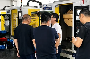 International buyer inspecting CNC machined parts at LuckyHxs factory