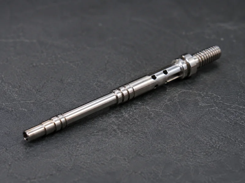 Complex slender shaft showing multiple machined features